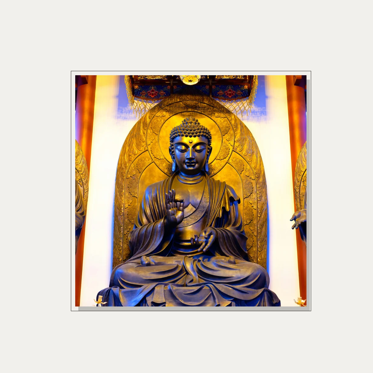 A majestic golden bronze statue of Gautama Buddha seated in meditation inside a temple shrine with warm overhead lighting. — floater frame preview | PrintPosters.in