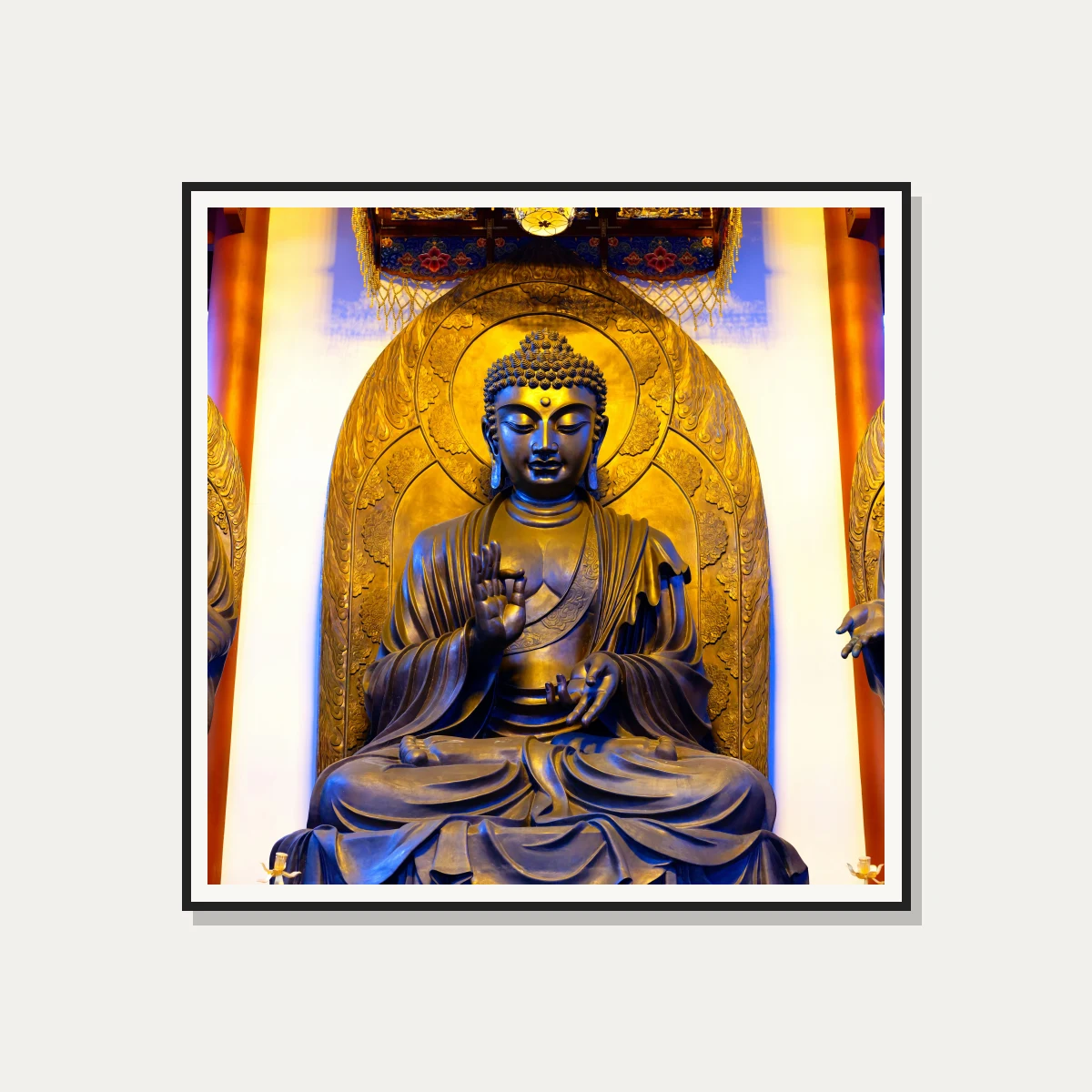 A majestic golden bronze statue of Gautama Buddha seated in meditation inside a temple shrine with warm overhead lighting. — photo frame preview | PrintPosters.in