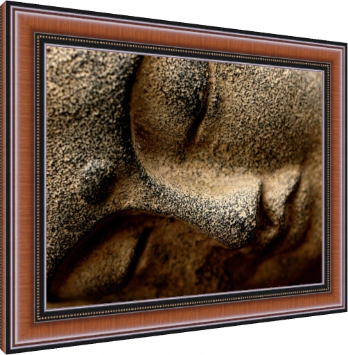 Extreme close-up of a textured stone sculpture of Lord Buddha's serene face, showing his closed eye and nose. — photo frame preview | PrintPosters.in