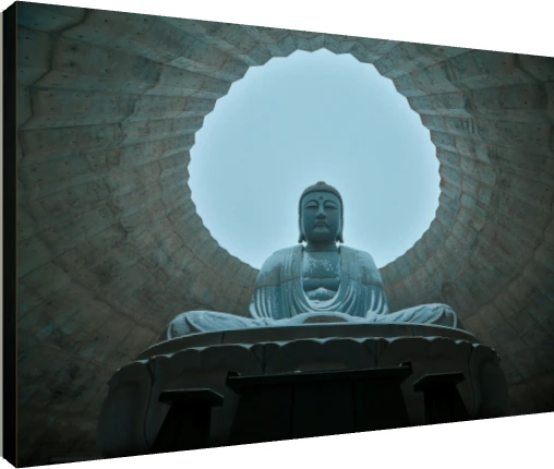 A low-angle photograph of a giant stone Lord Buddha statue framed by a circular concrete opening against a clear sky. | PrintPosters.in
