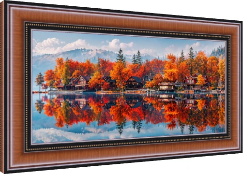 Panoramic view of fiery orange autumn trees and wooden lake houses mirrored in a calm, clear lake with mountains in background. — photo frame preview | PrintPosters.in